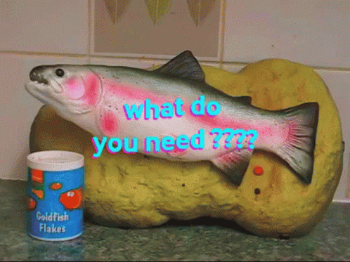 A Can Of Goldfish Flakes Sits Next To A Fish Figurine GIF