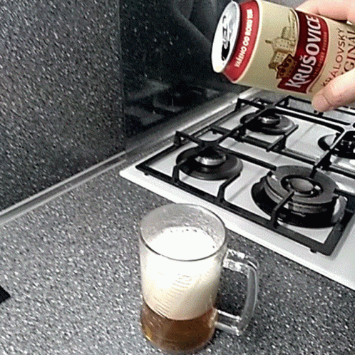 A Can Of Krusovice Is Poured Into A Glass GIF