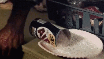 A Can Of Lays Chips Is Being Poured Into A Paper Plate On A Table GIF