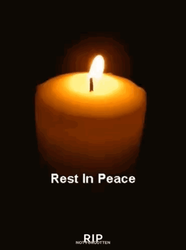 a candle is lit in the dark with the words `` rest in peace '' written below it .