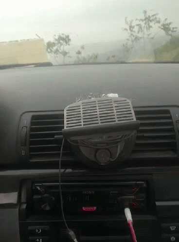 A Car Dashboard With A Sony Radio And A Fan Attached To It GIF