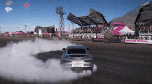 A Car Is Drifting On A Track That Says Horizon Festival On It GIF