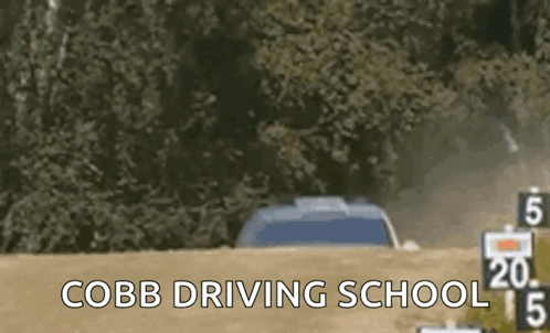 A Car Is Driving Down A Dirt Road With The Words Cobb Driving School In The Corner GIF
