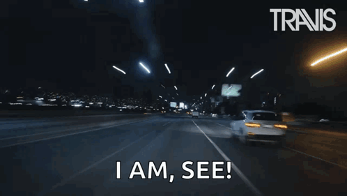 A Car Is Driving Down A Highway At Night And Says I Am See . GIF