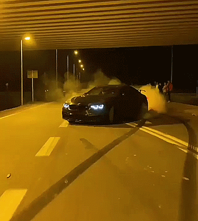A Car Is Driving Down A Highway At Night GIF