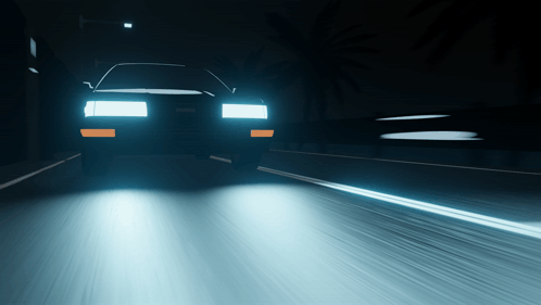A Car Is Driving Down A Highway At Night GIF