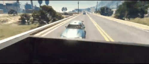 A Car Is Driving Down A Highway In A Video Game .. GIF