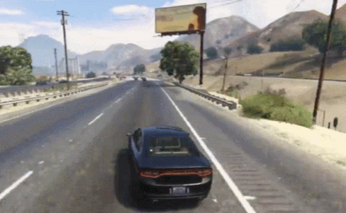 A Car Is Driving Down A Highway In Front Of A Billboard GIF