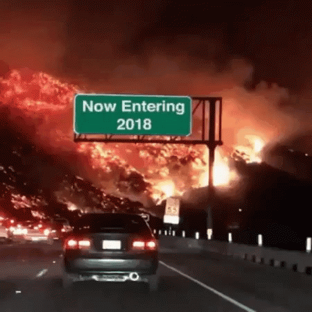 A Car Is Driving Down A Highway In Front Of A Sign That Says Now Entering 2018 GIF