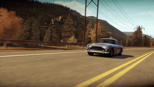 A Car Is Driving Down A Highway With Mountains In The Background GIF