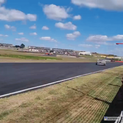 A Car Is Driving Down A Race Track With The Word Kapwing On The Bottom GIF