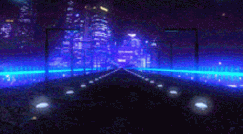 A Car Is Driving Down A Road At Night With A City In The Background . GIF