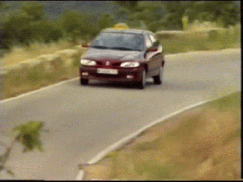 A Car Is Driving Down A Road With A License Plate That Says ' Tc ' On It GIF
