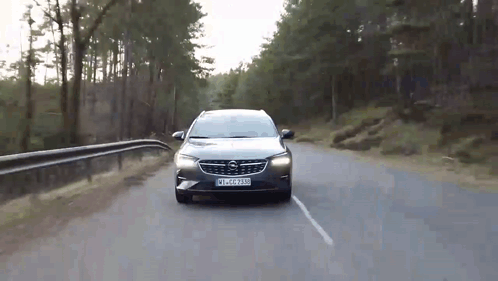 A Car Is Driving Down A Road With A License Plate That Says Wlc - 2230 GIF