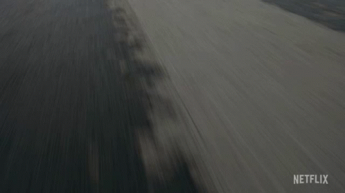 A Car Is Driving Down A Road With A Netflix Logo On The Bottom Right GIF