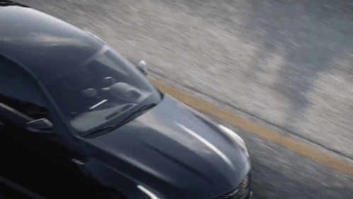 A Car Is Driving Down A Road With A Yellow Line In The Middle GIF