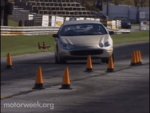 A Car Is Driving Down A Road With Motorweek.org Written On The Bottom Of The Screen GIF