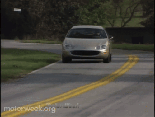 A Car Is Driving Down A Road With Motorweek.org Written On The Bottom Of The Screen GIF