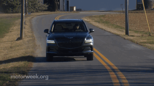 A Car Is Driving Down A Road With Motorweek.org Written On The Side GIF