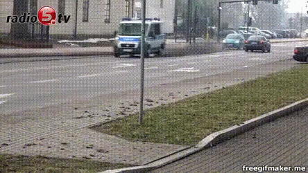A Car Is Driving Down A Street In Front Of A Building That Says Radio 9 Tv On It GIF