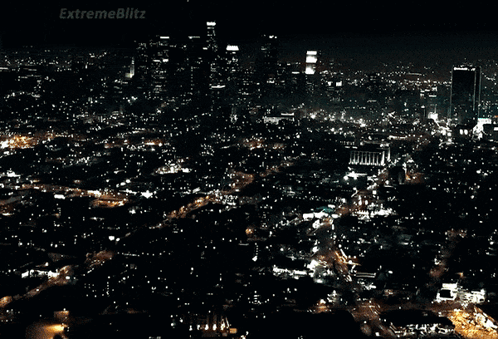 A Car Is Driving Down A Street With A Sign That Says Extremeblitz On It GIF