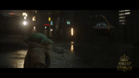 A Car Is Driving Down A Wet Street At Night With A Krhb Logo In The Corner GIF
