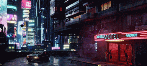 A Car Is Driving Past A Motel With A Vacancy Sign GIF