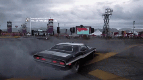 A Car Is Driving Past A Sign That Says Hall Of Fame GIF