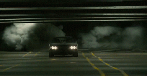 A Car Is Driving Under A Bridge With Smoke Coming Out Of The Windshield GIF