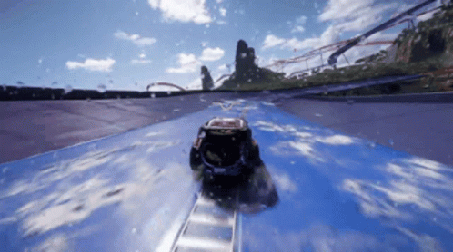 A Car Is Going Down A Roller Coaster Track With A Red Bull Logo On The Side GIF