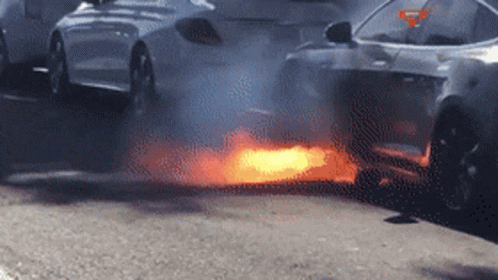 A Car Is On Fire And Smoke Is Coming Out Of The Exhaust Pipe GIF