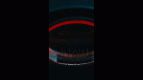 A Car Is Parked In Front Of A Building In The Dark GIF