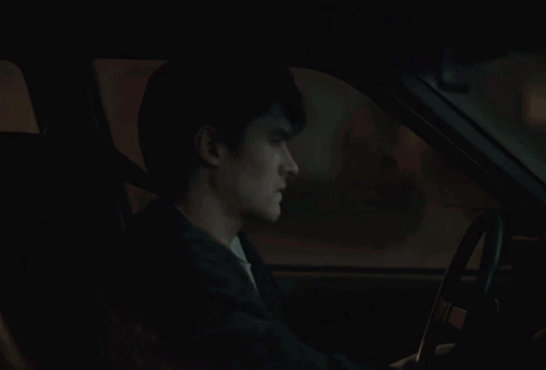 A Car Is Parked In Front Of A House With A Picture Of A Man And The Words True On It GIF