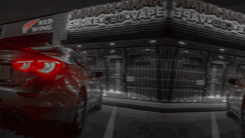A Car Is Parked In Front Of A Store Called Bahamas Smoke Cbd Vape GIF