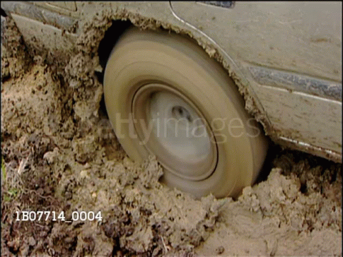 A Car Is Stuck In The Mud And Has The Number 1B07714_0004 On The Bottom Right GIF