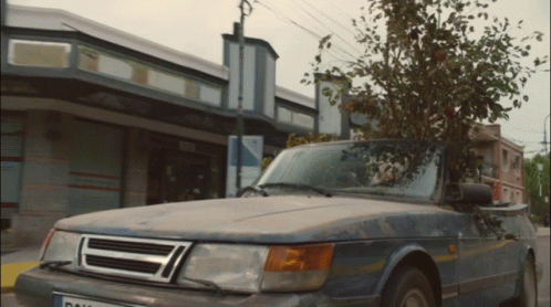 A Car Parked In Front Of A Building With A License Plate That Says ' Dal ' On It GIF