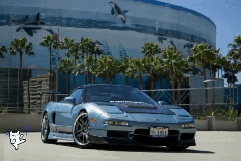 A Car With A License Plate That Says 1691 Is Parked In Front Of A Building GIF