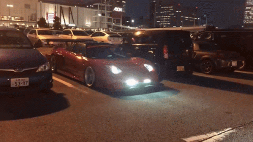 A Car With A License Plate That Says 53-97 Is Driving Down The Road GIF