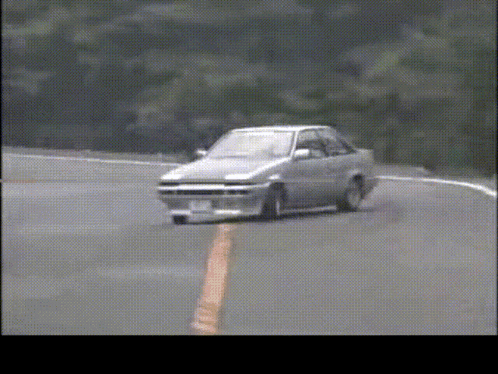 A Car With A License Plate That Says ' A ' On It Is Driving Down A Road GIF