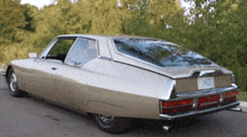 A Car With A License Plate That Says ' Nc ' On It Is Parked On The Side Of The Road GIF