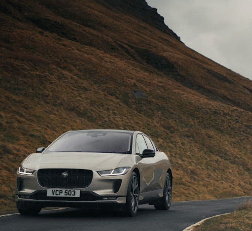 A Car With A License Plate That Says Vcp 503 Drives Down A Road GIF