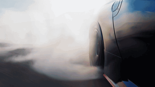 A Car With Smoke Coming Out Of Its Tire GIF