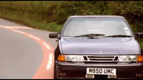 A Car With The License Plate M850 Umc Is Driving Down A Road GIF