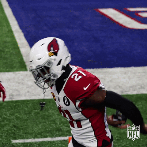 A Cardinals Football Player Is Running With The Ball On The Field GIF