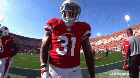 A Cardinals Football Player Stands On The Field GIF