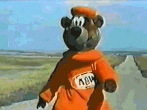 A Cartoon Bear Wearing An Orange Jacket With The Word Nov On The Back GIF
