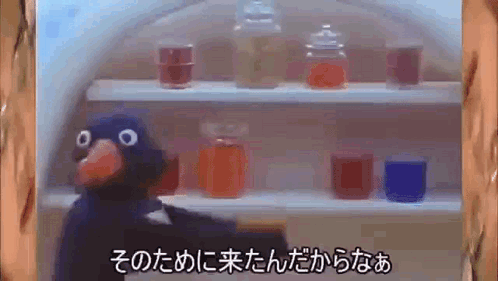 A Cartoon Bird Is Standing In Front Of A Shelf With Jars On It In A Foreign Language . GIF