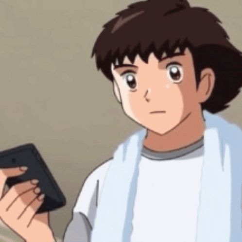 a cartoon boy is holding a cell phone in his hand .