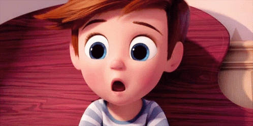 A Cartoon Boy With Big Blue Eyes Is Sitting On A Bed With His Mouth Open . GIF