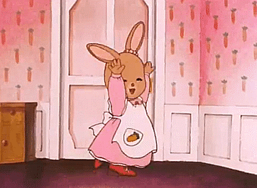 A Cartoon Bunny In A Pink Dress And Apron Is Dancing In A Room With Carrots On The Wall . GIF